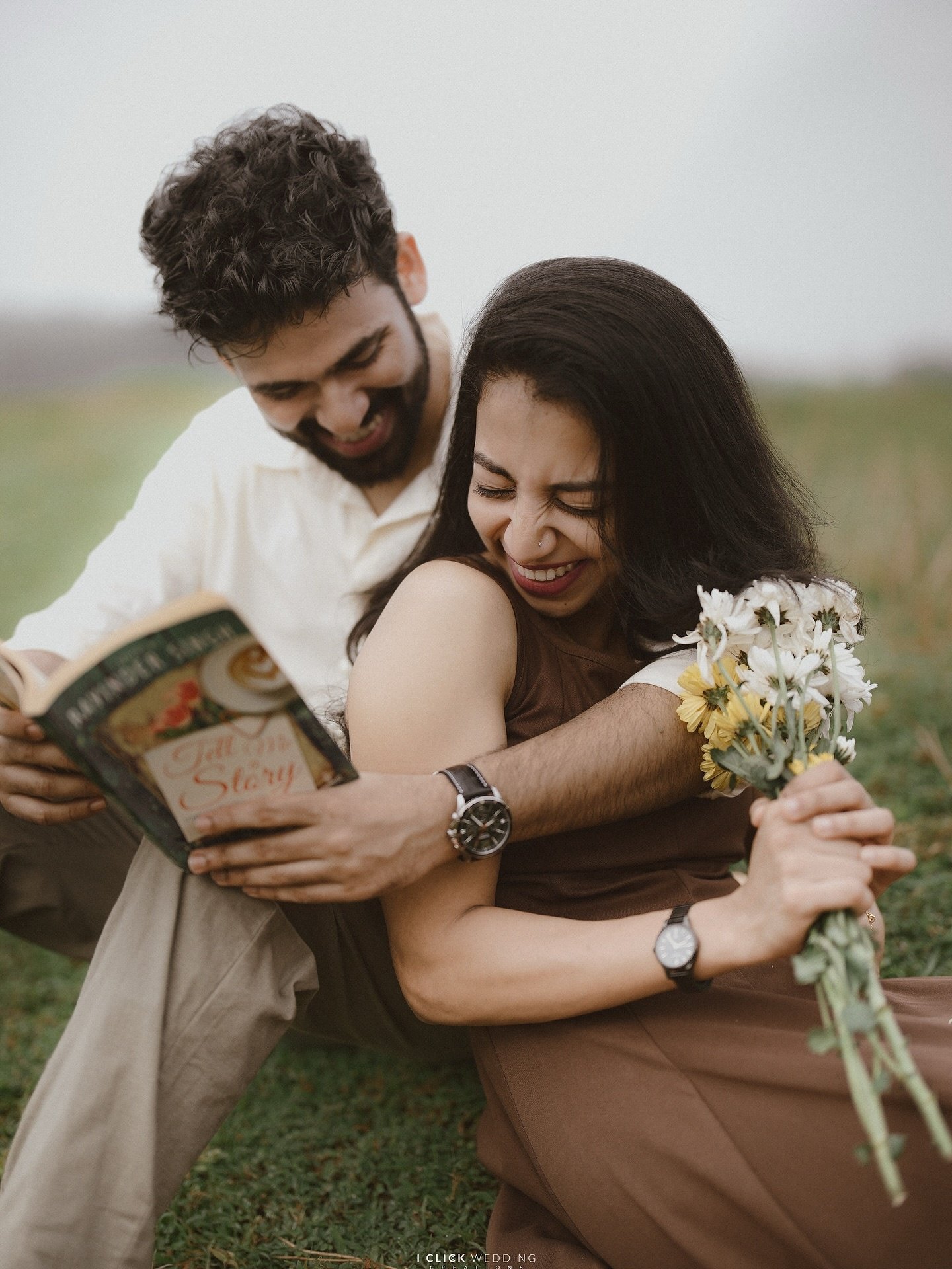A couple laughing together outdoors